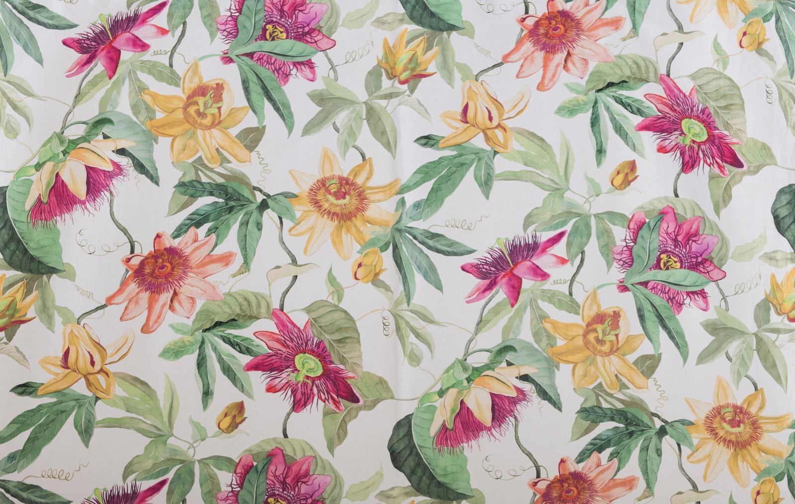 Large painterly floral fabric with magenta, yellow and green blooms on a pale ground