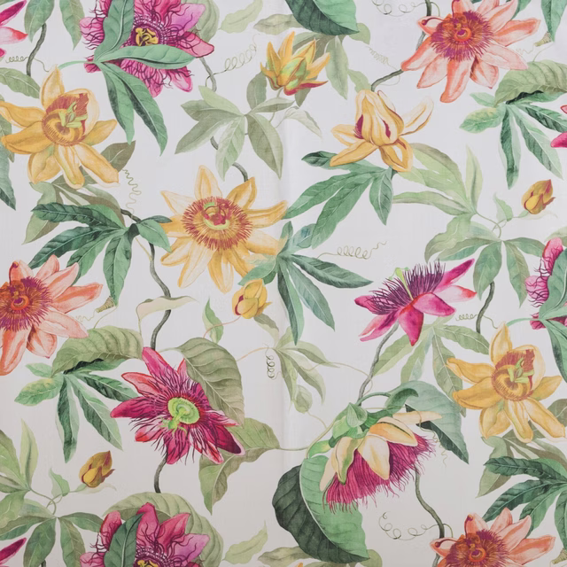 Large painterly floral fabric with magenta, yellow and green blooms on a pale ground