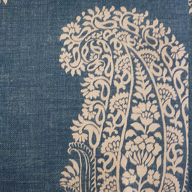 Muted denim blue printed fabric with a large cream paisley motif