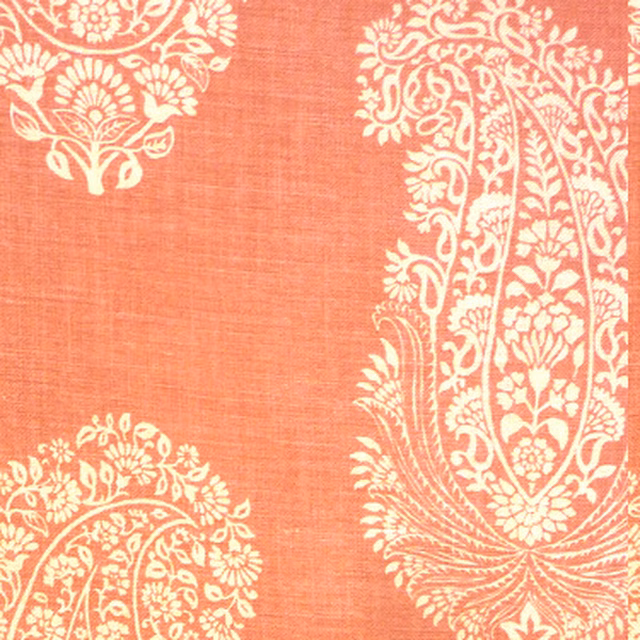 Coral pink printed fabric with large ivory paisley damask motifs