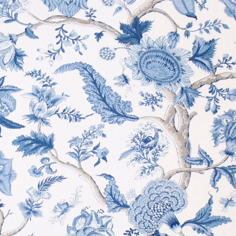 Blue floral branch print on a pale ground with soft indigo and mist tones