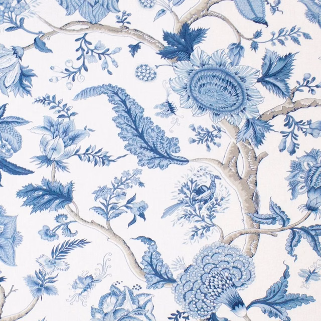 Blue floral branch print on a pale ground with soft indigo and mist tones
