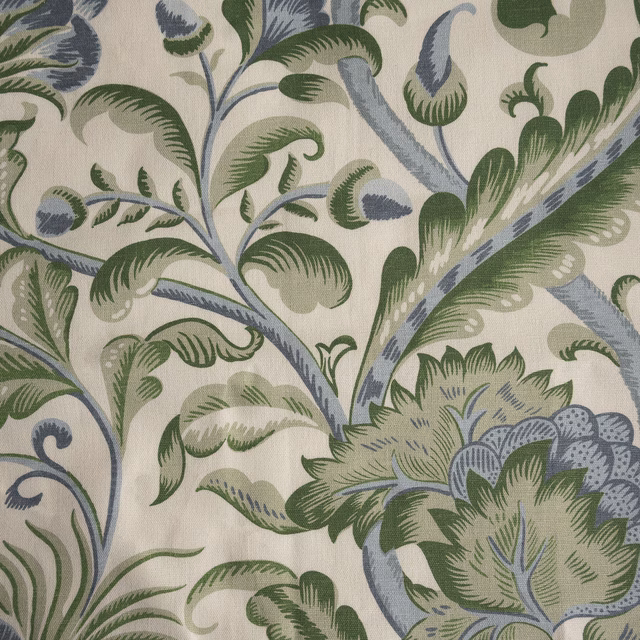 Cream botanical fabric with large green and blue-grey scrolling leaves