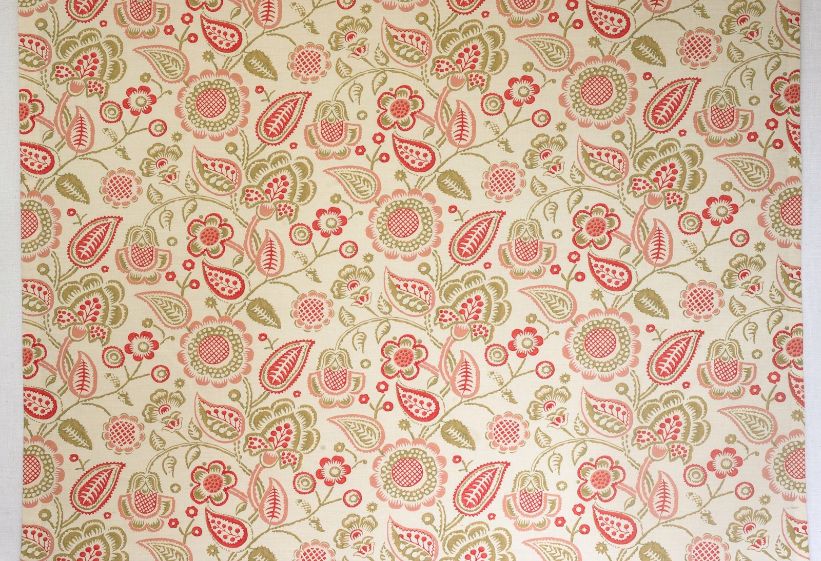 Cream floral patterned fabric with coral and olive folk motifs