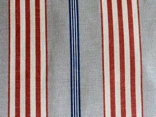 Pale grey striped fabric with red bands and a central blue stripe