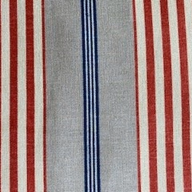 Pale grey striped fabric with red bands and a central blue stripe