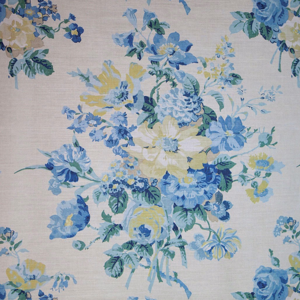 Blue and green floral fabric on a pale textured ground