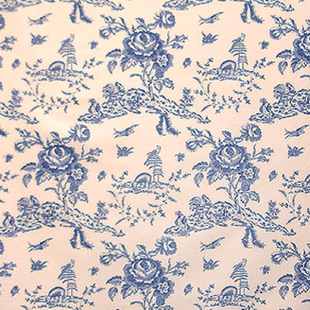 Blue toile fabric on cream ground with pastoral scenes and floral motifs