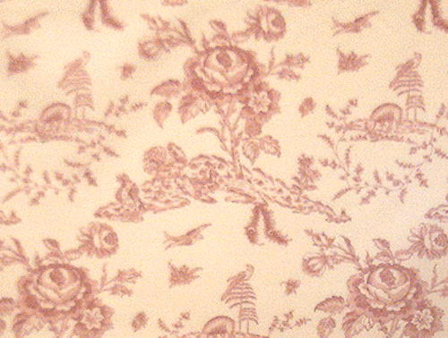 Pink toile fabric with floral sprays, birds and basket motifs on a cream ground