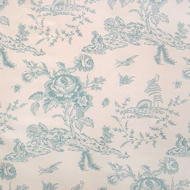 Pale blue toile fabric with pastoral figures and floral motifs on ivory