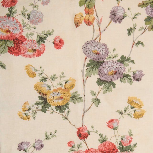 Cream-yellow floral fabric swatch with painterly pink, lilac and yellow blooms