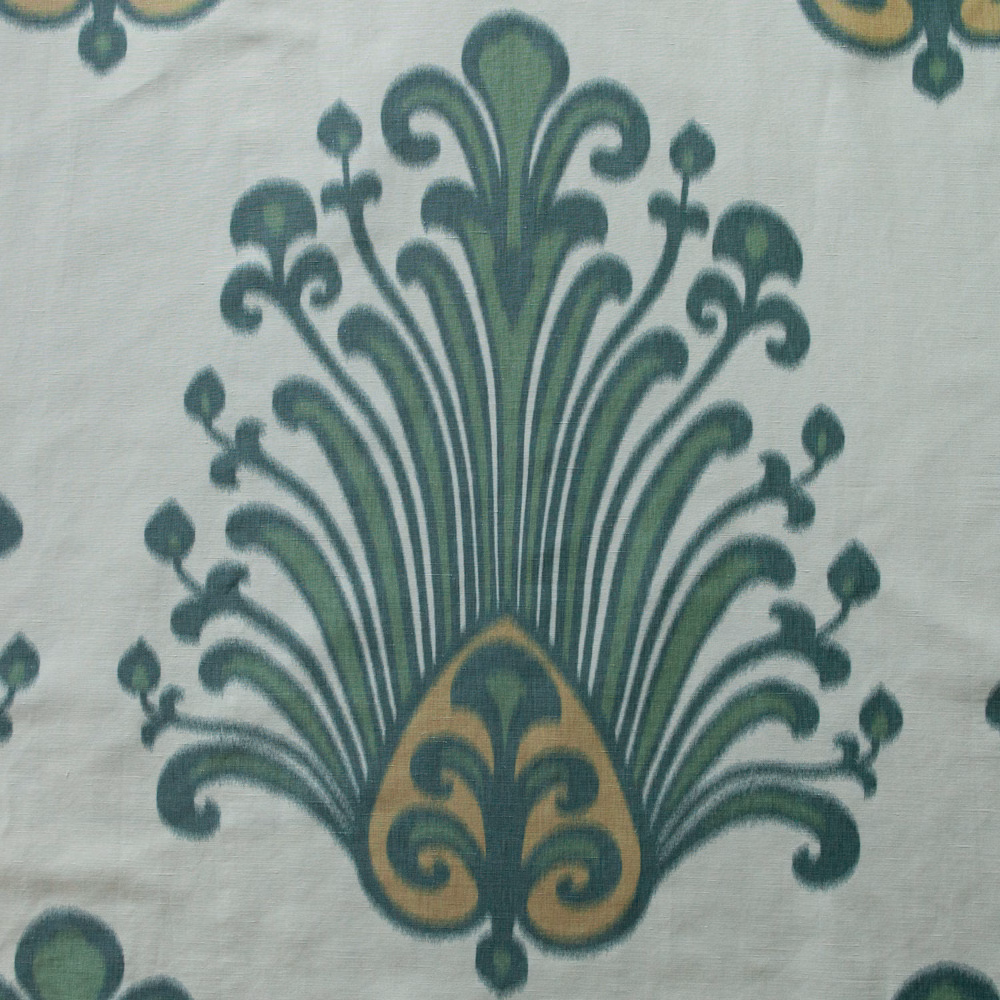 Large green and ochre damask print on a pale ground