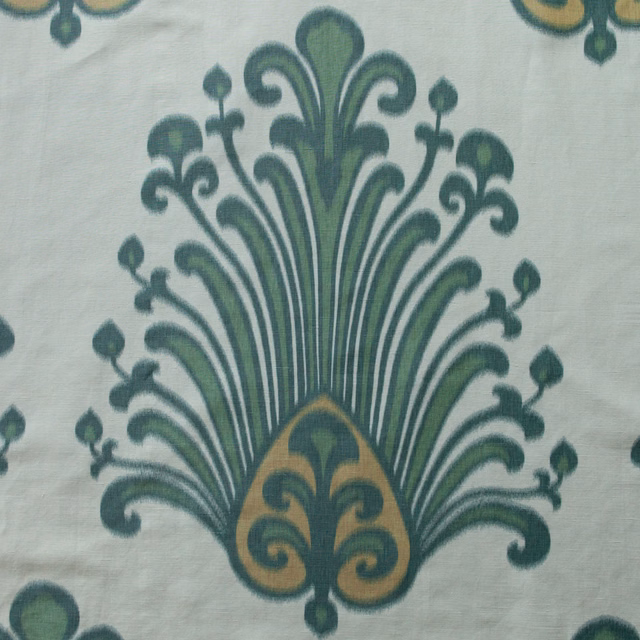 Large green and ochre damask print on a pale ground