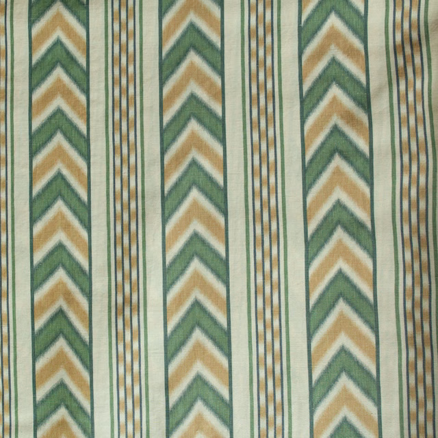 Vertical green and ochre chevron stripes on a pale woven ground