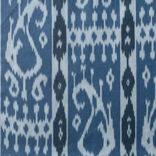 Close-up of blue and white paisley web fabric with bold vertical stripes