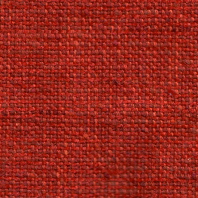 Close-up of rich paprika-red woven fabric with a compact textured surface