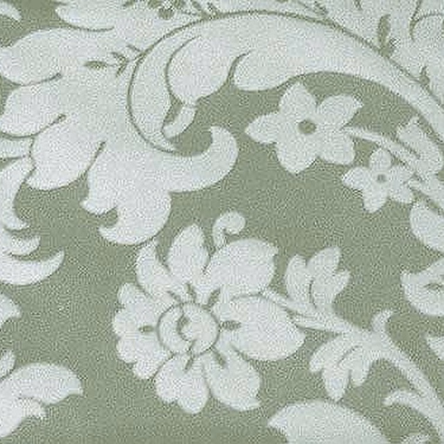 Soft sage green woven damask fabric with pale scrolling floral motif