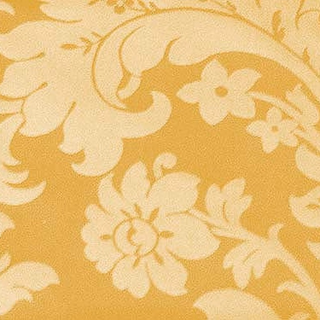 Golden yellow woven fabric with large cream scrolling floral motif