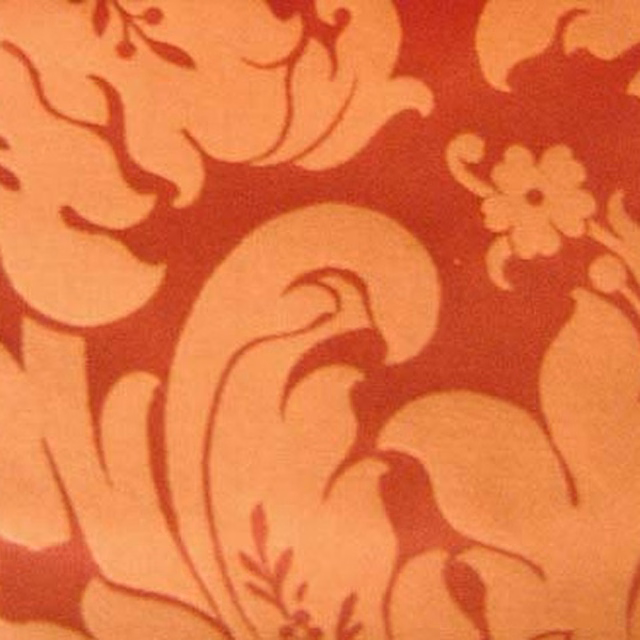 Large coral-orange woven floral fabric with terracotta-red patterning