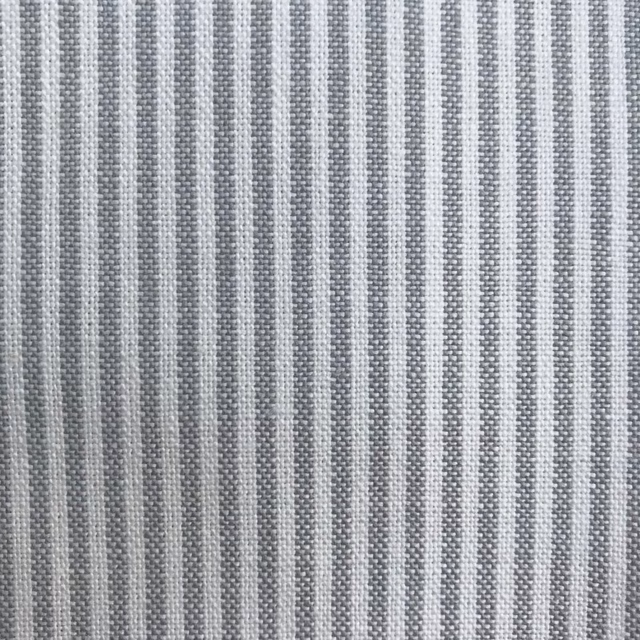 Close-up of a soft grey woven stripe fabric with fine textured bands
