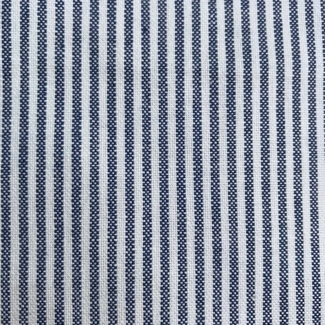 Close-up of narrow Prussian blue and off-white vertical striped woven fabric