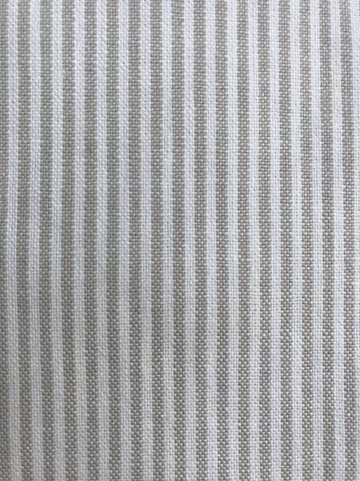 Close-up of soft stone-grey woven stripe fabric with fine vertical texture