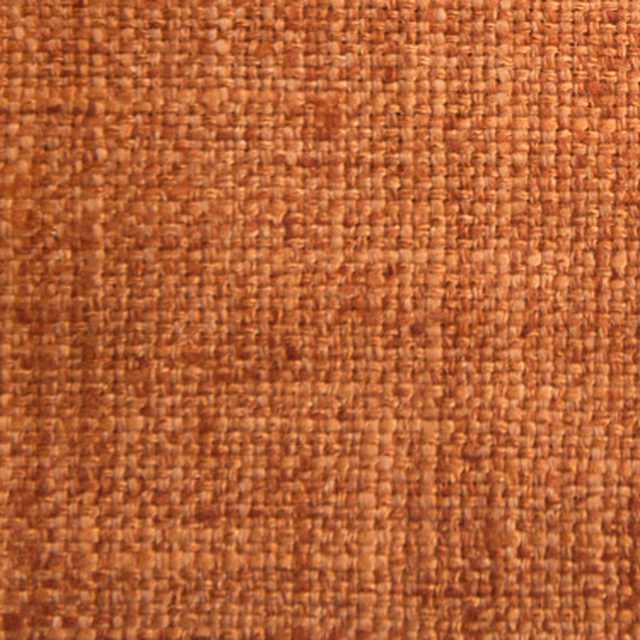 Close-up of a warm paprika woven fabric with a textured plain surface