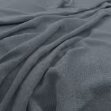 Cool slate blue-grey fabric with fine woven texture in soft draped folds