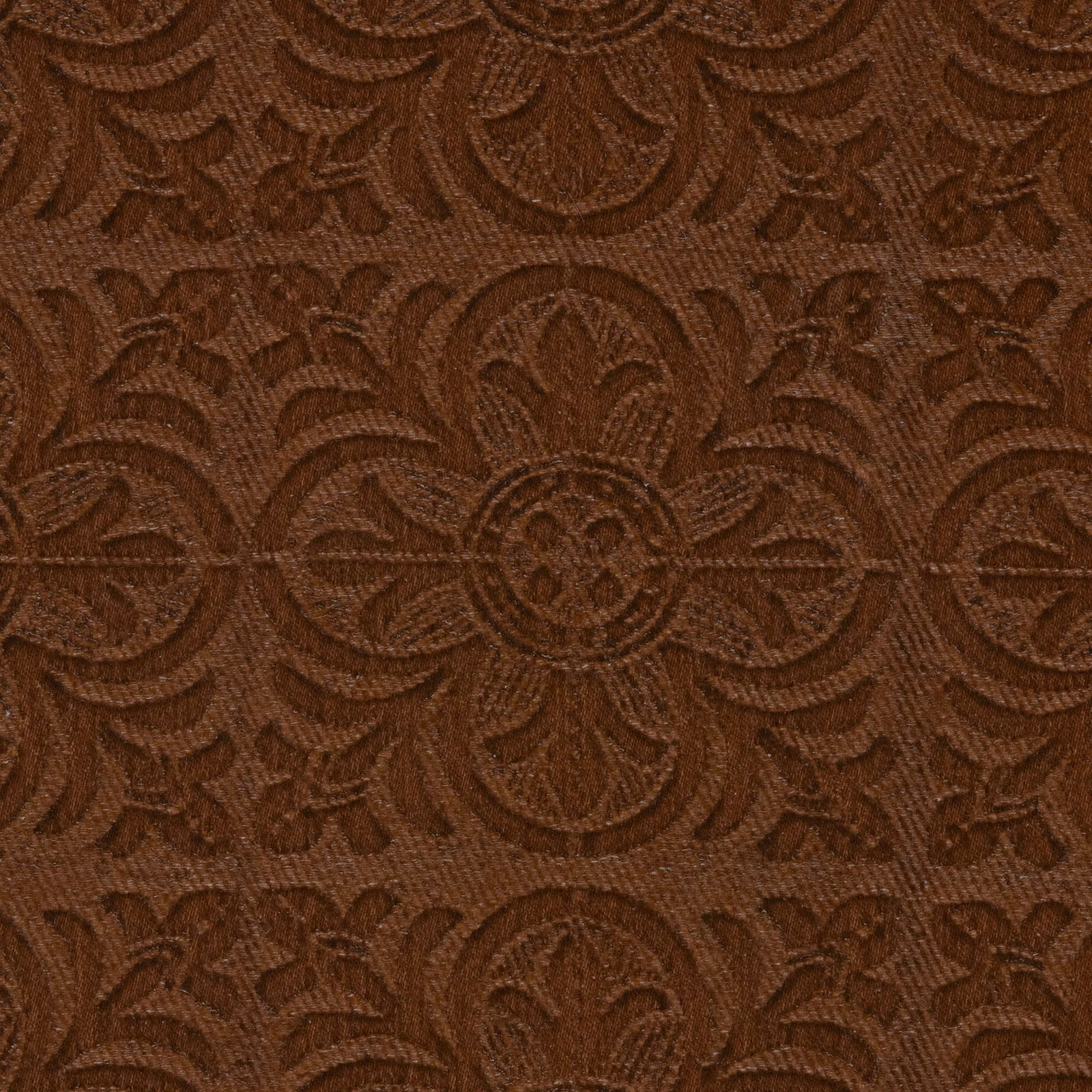 Close-up of warm russet-brown damask with raised medallions and fine woven texture