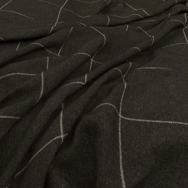 Deep charcoal fabric with pale looping lines and a softly textured woven surface