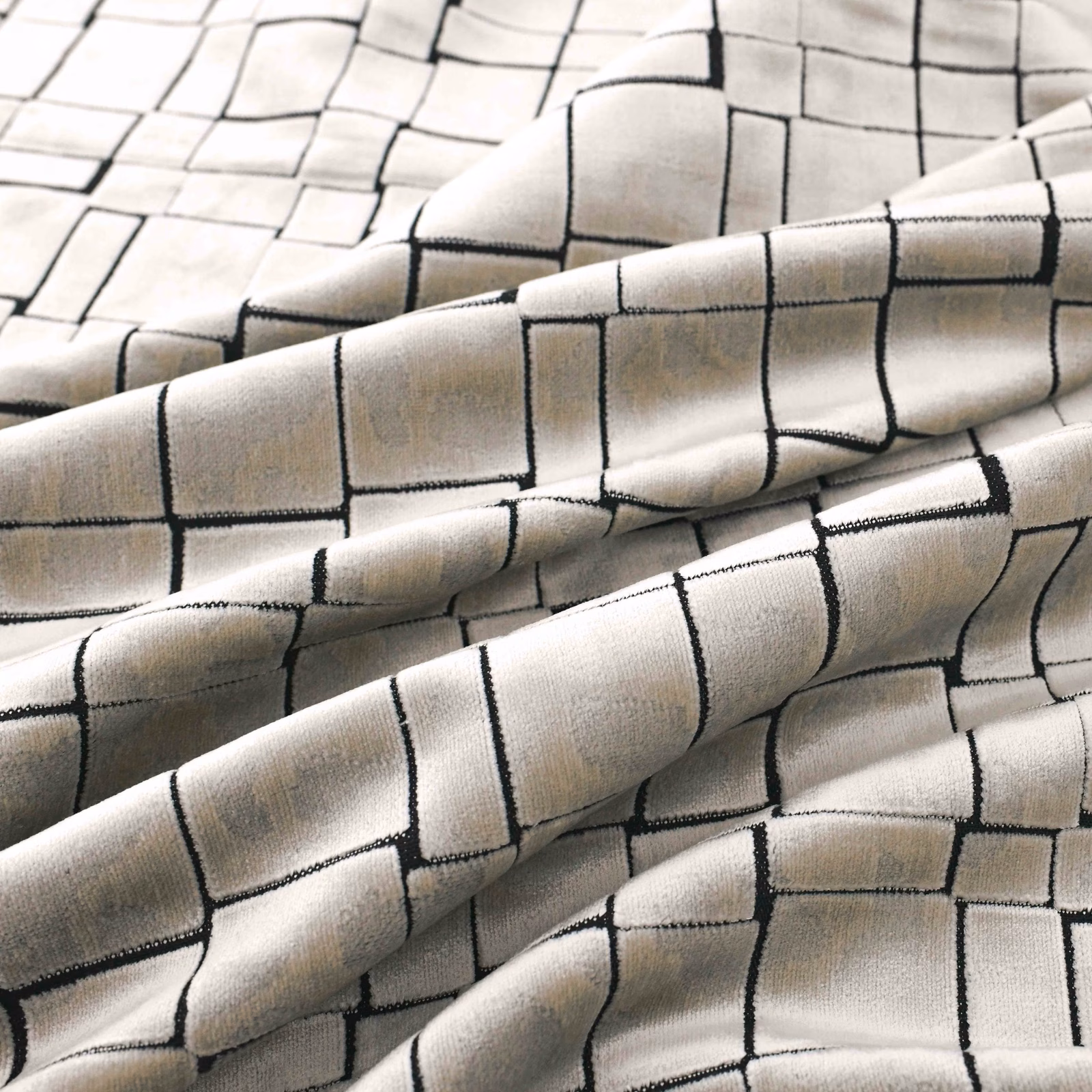 Pearl cream fabric with black outlined rectangles across softly folded, lightly lustrous cloth