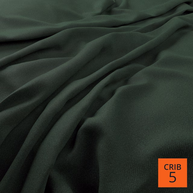Deep hunter-green fabric falling in soft matte folds with subtle surface texture
