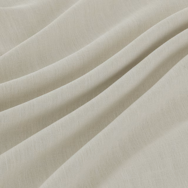 Pale chalk-ivory plain weave fabric falling in soft, fluid folds