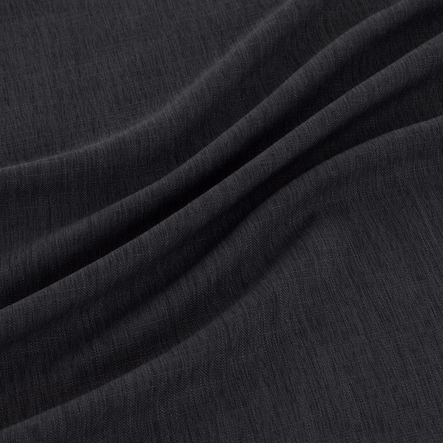 Near-black indigo fabric with fine vertical weave falling into soft folds