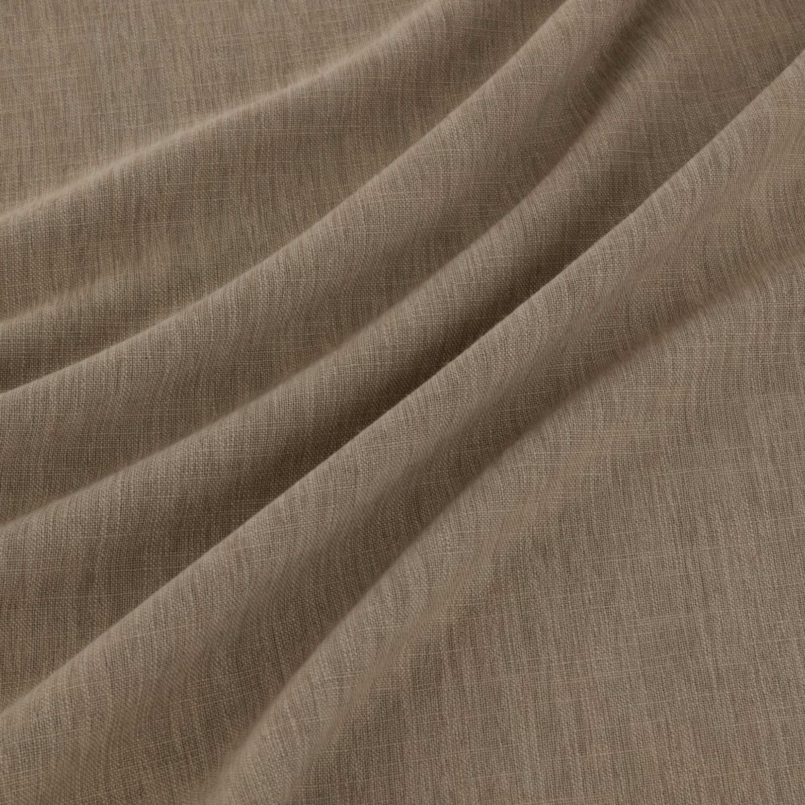 Warm praline taupe fabric with fine woven texture falling in soft diagonal folds