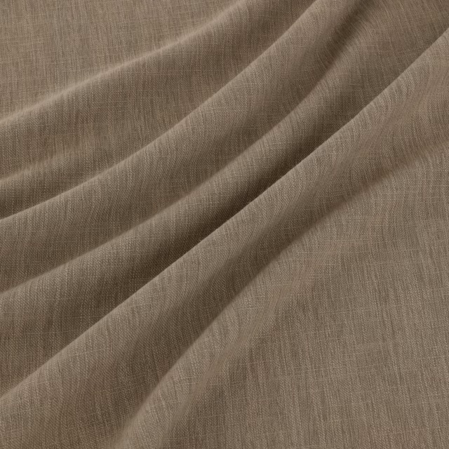 Warm praline taupe fabric with fine woven texture falling in soft diagonal folds