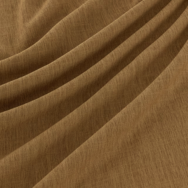 Warm pumpkin-brown woven textile draped in broad folds with fine linear texture