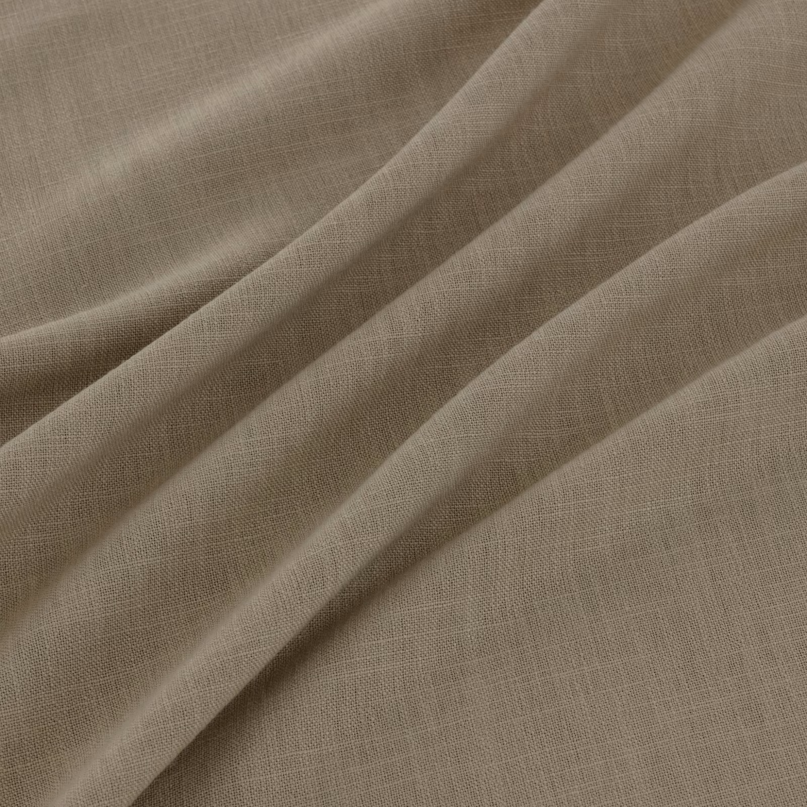 Warm sesame-taupe plain weave fabric falling in softly layered folds