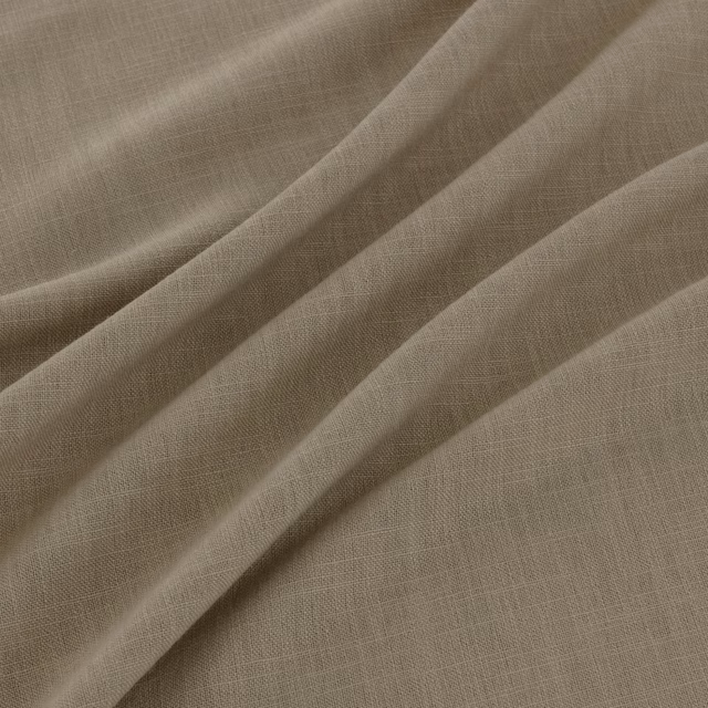 Warm sesame-taupe plain weave fabric falling in softly layered folds