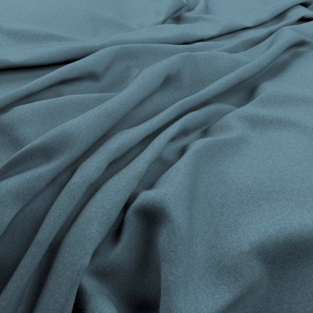 Close-up of muted blue-teal plain fabric falling in soft fluid folds