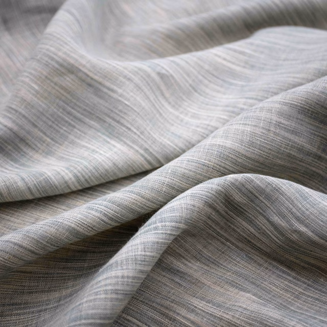 Pale eau de nil fabric with fine silvery striations folding into soft waves