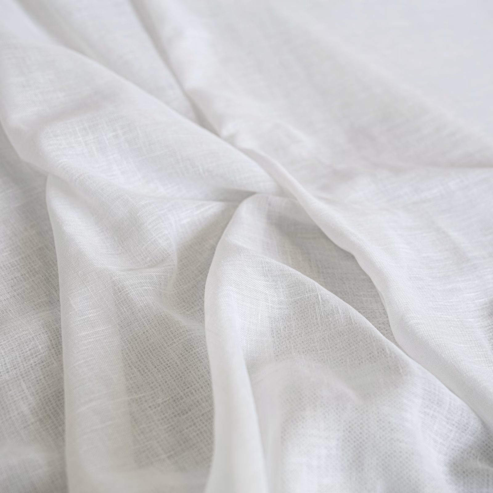 Soft ivory fabric with a delicate crosshatched weave, gathered into fluid folds