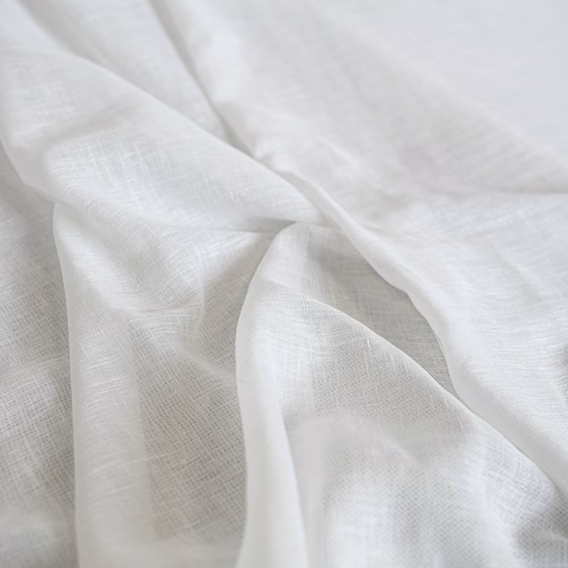 Soft ivory fabric with a delicate crosshatched weave, gathered into fluid folds