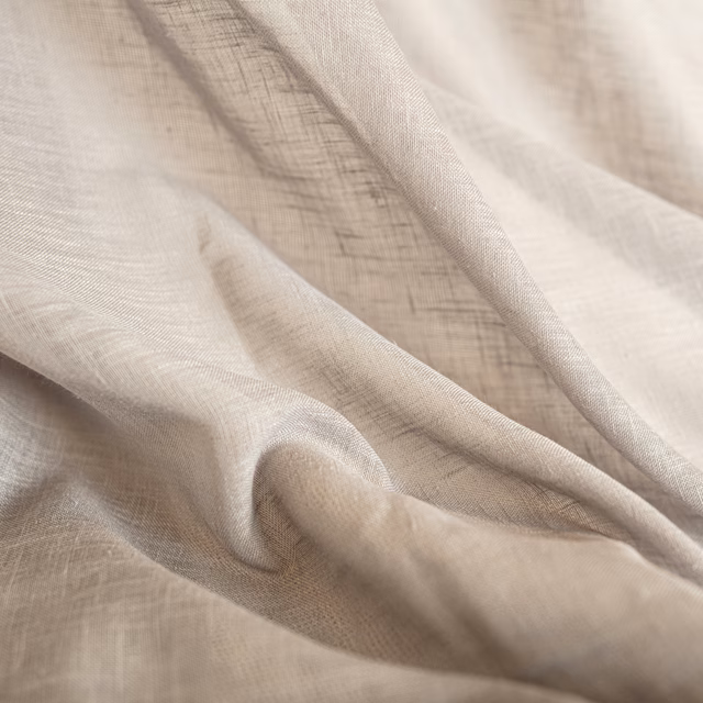 Warm ivory-beige woven fabric softly gathered, showing fine crosshatch texture and fluid folds.