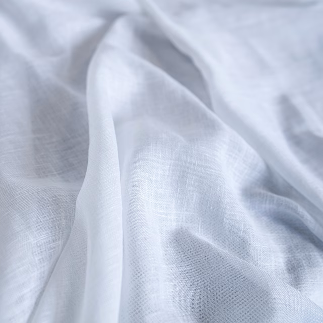 Icy blue-white finely woven fabric draped in translucent, softly folded layers