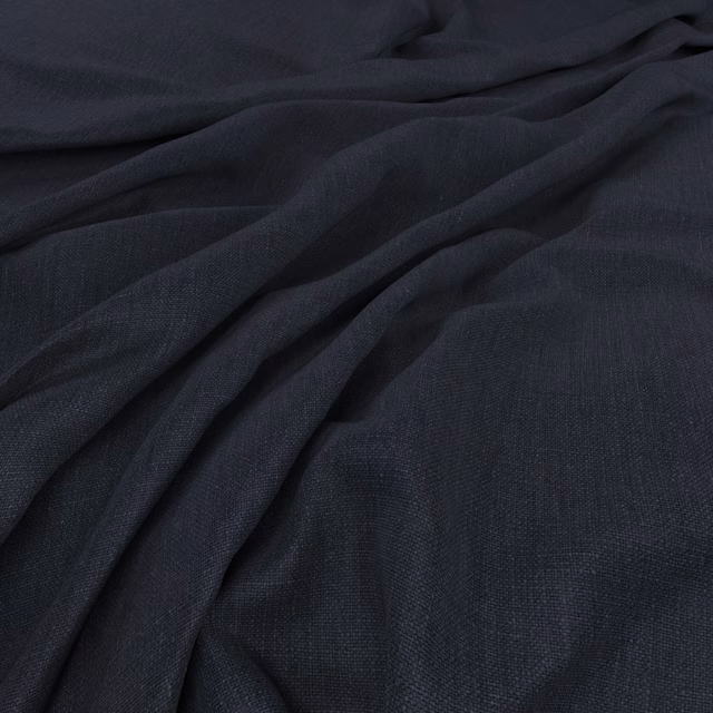 Deep indigo plain weave gathered into soft, shadowed folds