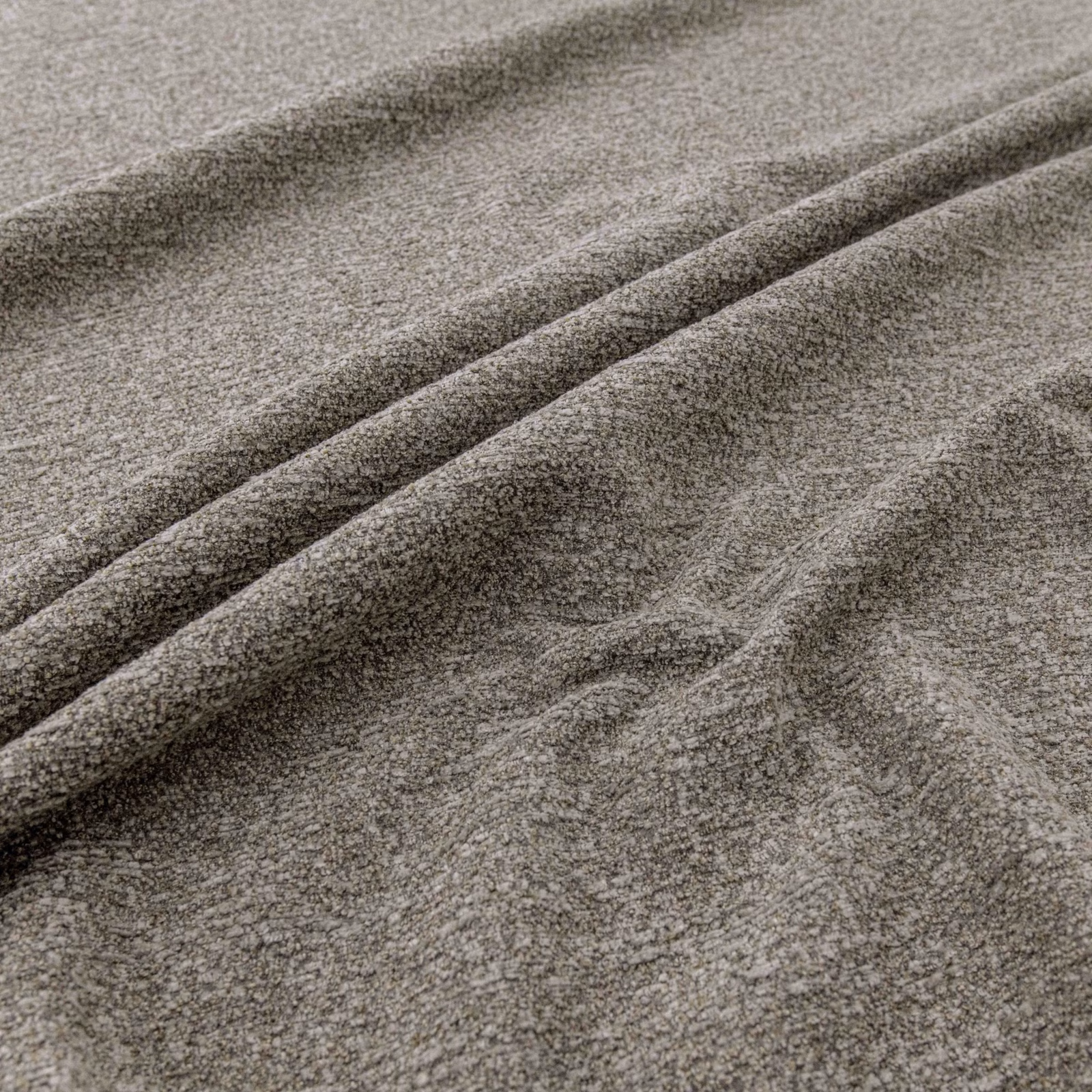 Warm fawn-grey textured fabric folded into soft diagonal ridges
