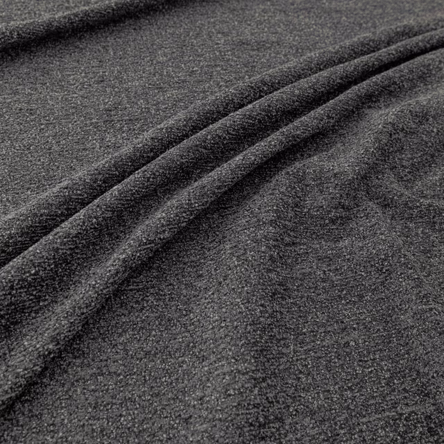 Deep graphite-grey textile with a close mottled grain and soft diagonal folds