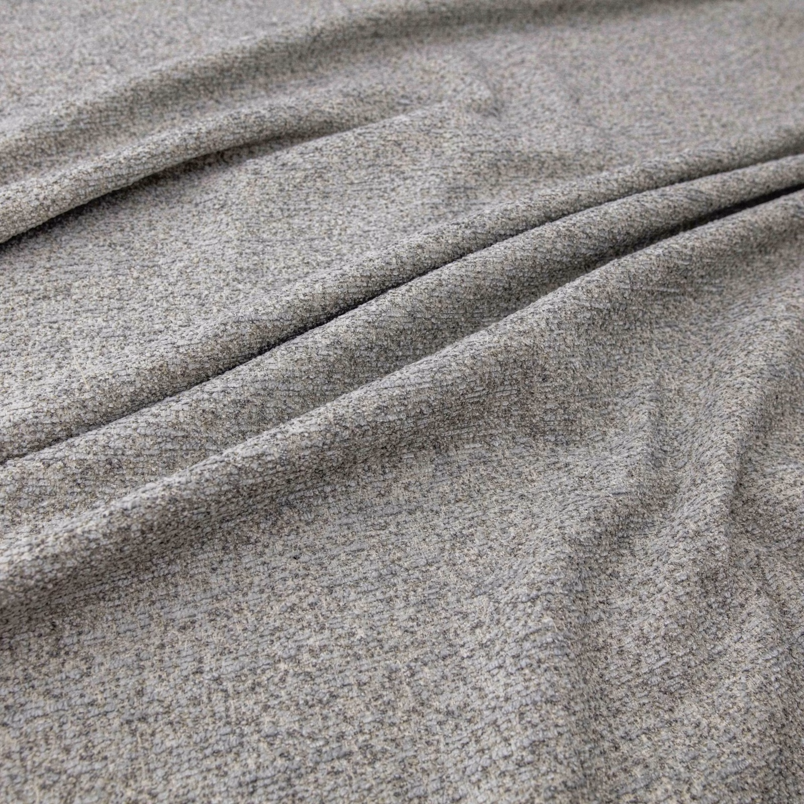 Close view of Arran Mist’s cool grey-taupe flecked weave falling into soft folds