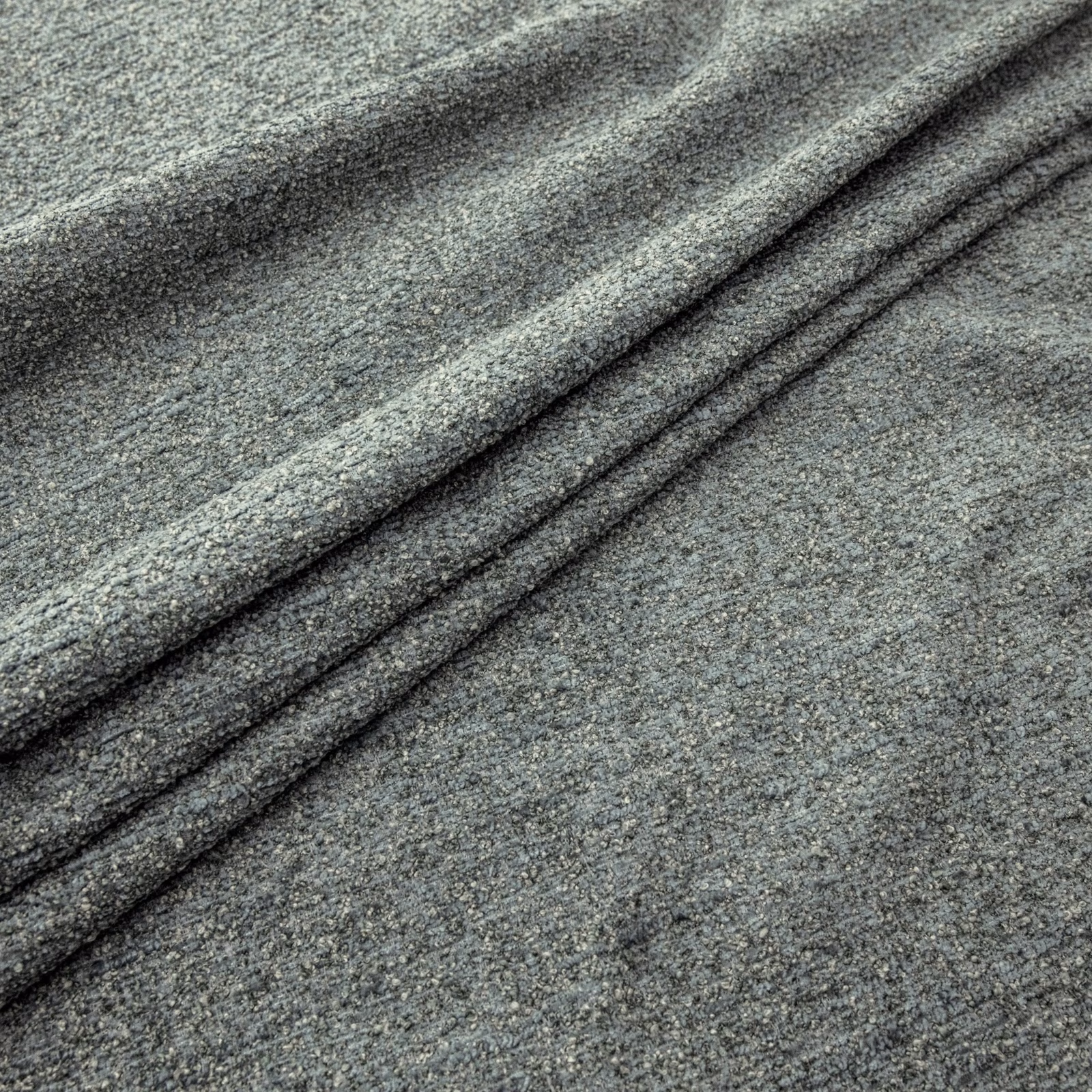 Muted seafoam-grey nubby weave gathered into soft diagonal folds